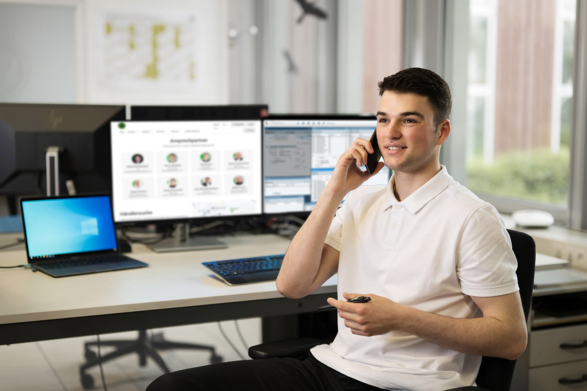 A KUKKO employee sits at his desk and makes a phone call