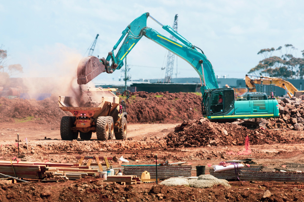 Excavator and truck on construction site to the industry commercial vehicles