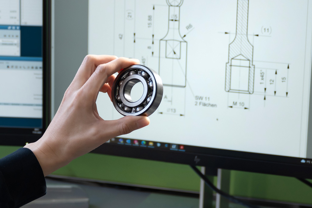 A ball bearing in front of a screen on the industry ball bearings